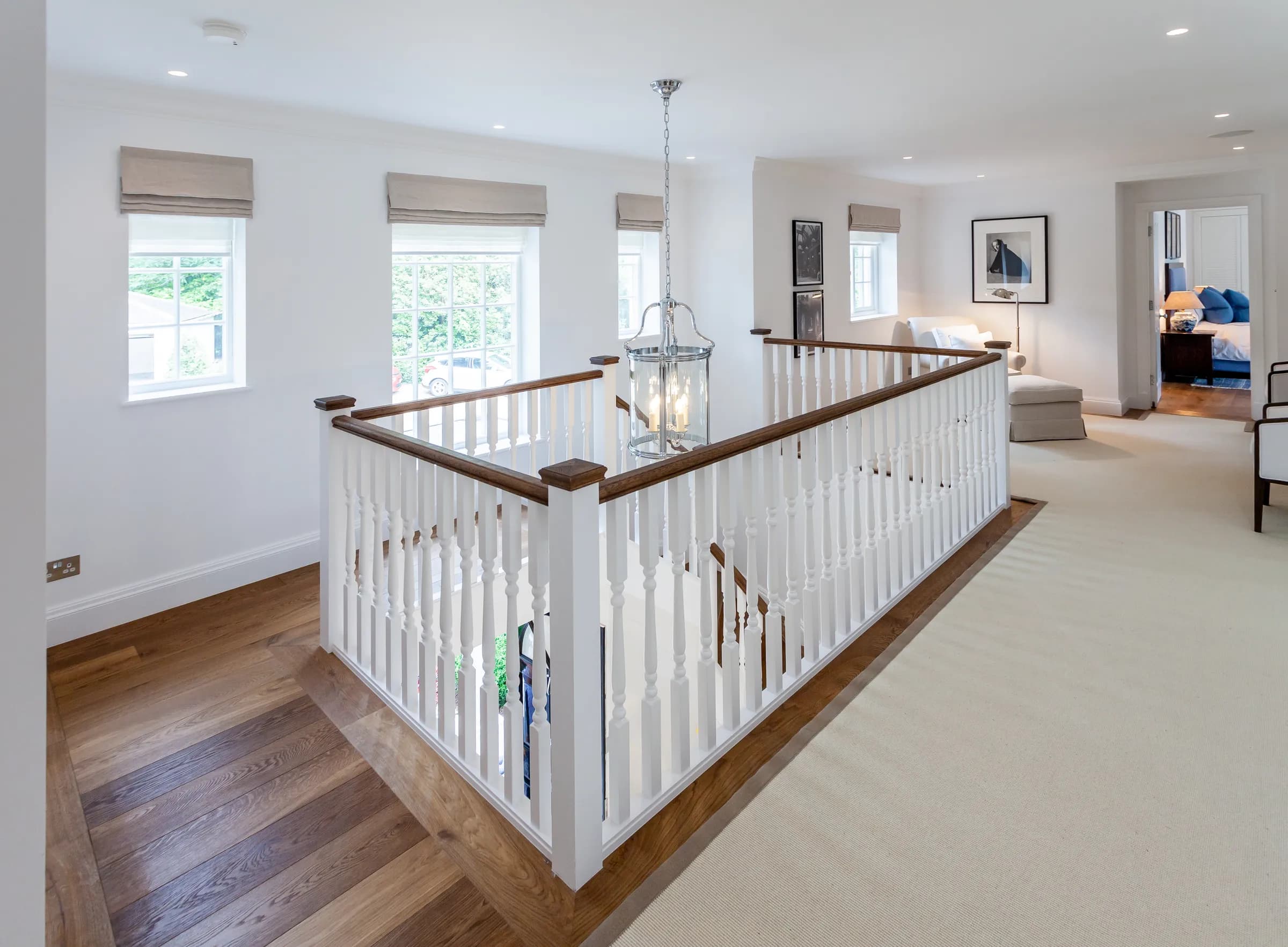 Elegant staircase with period banister and chandelier in a luxury new build