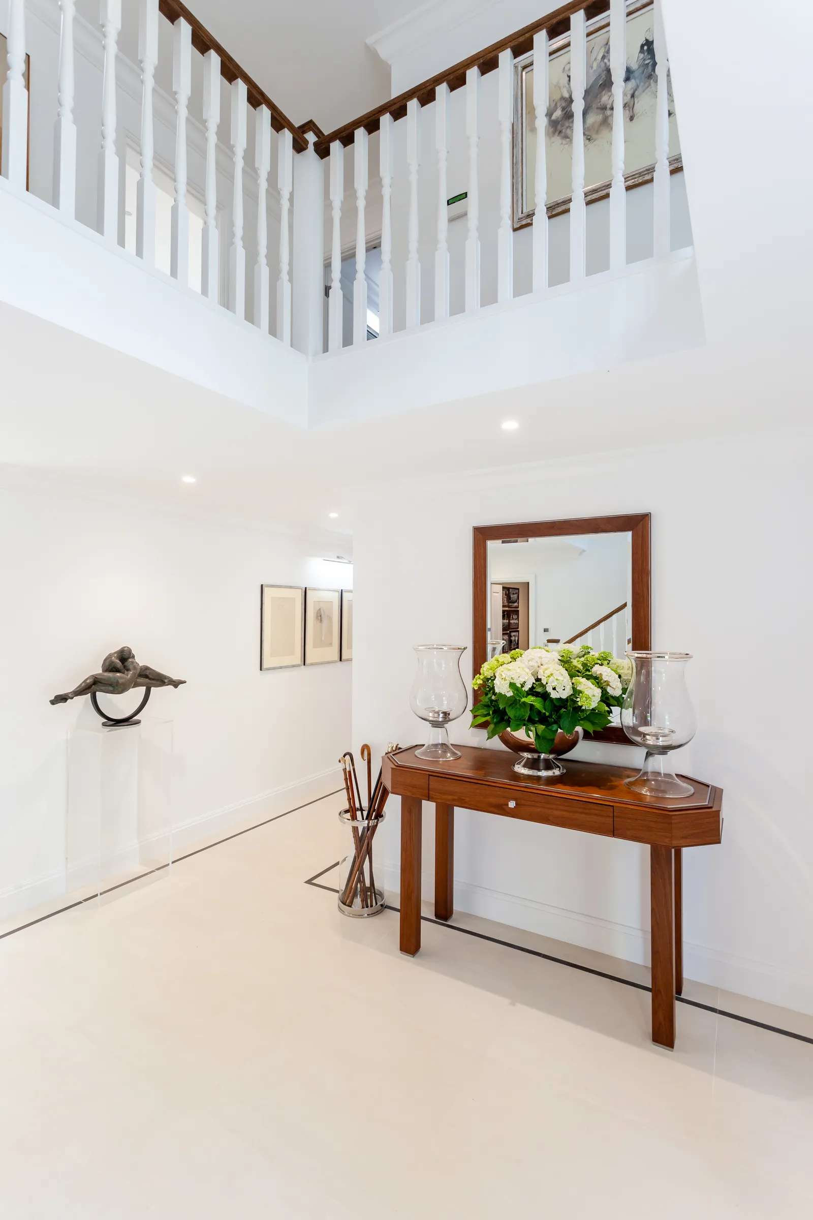 Grand foyer with console table, sculptural arrangement and classical interior detailing